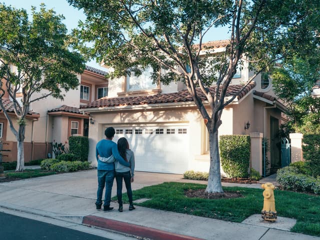 Couple in front of home